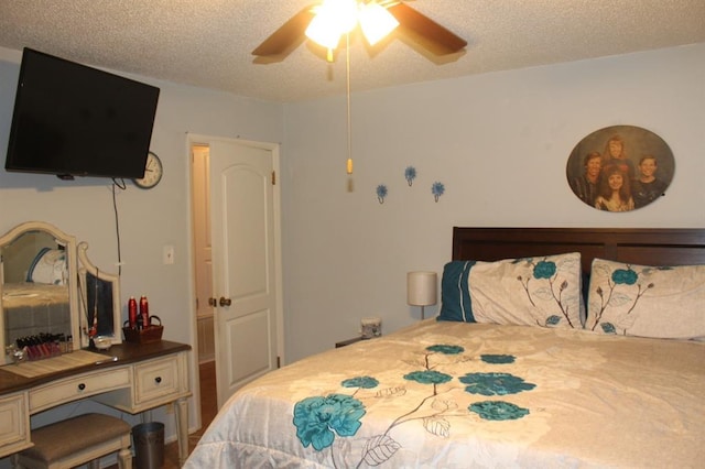 bedroom with ceiling fan and a textured ceiling