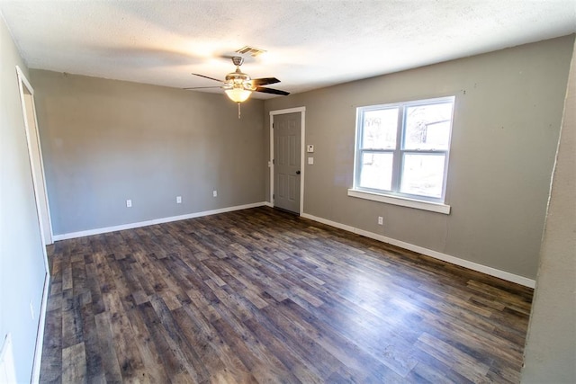 unfurnished room featuring a textured ceiling, ceiling fan, and dark wood-type flooring