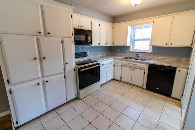 kitchen featuring white cabinetry, sink, light tile patterned flooring, and black appliances