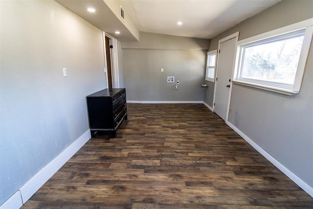 clothes washing area with dark wood-type flooring