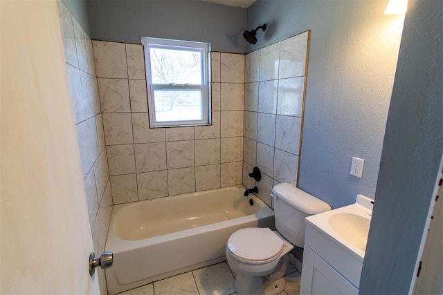 full bathroom featuring tile patterned flooring, vanity, toilet, and tiled shower / bath