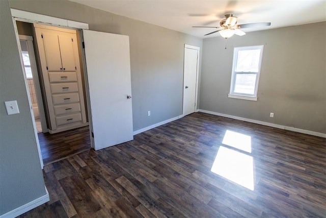 unfurnished bedroom with a closet, ceiling fan, and dark wood-type flooring