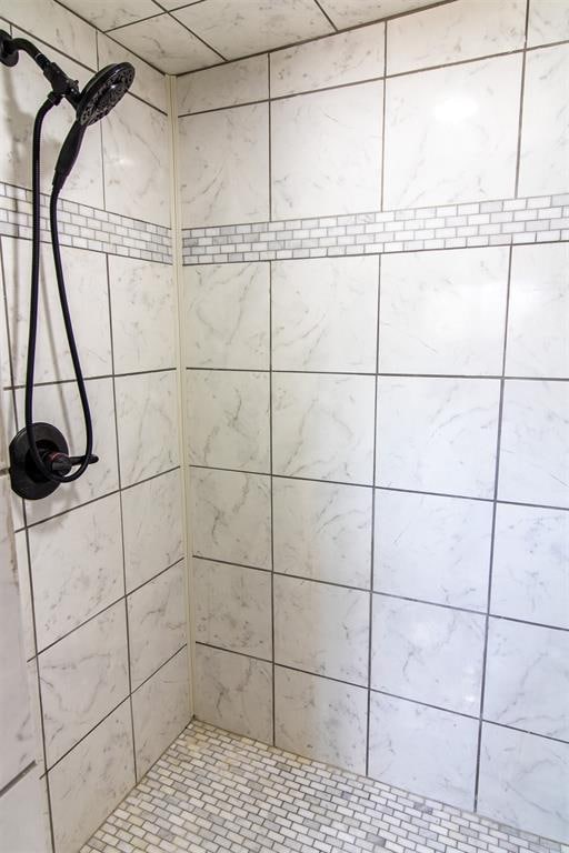 bathroom with tiled shower