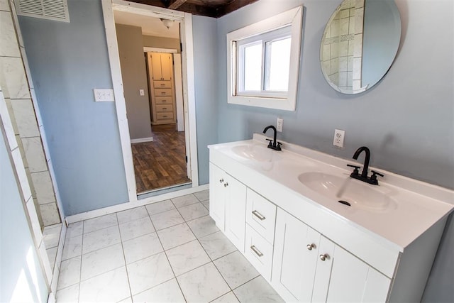 bathroom featuring tile patterned flooring and vanity