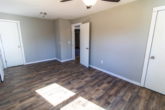 unfurnished bedroom featuring ceiling fan and dark wood-type flooring