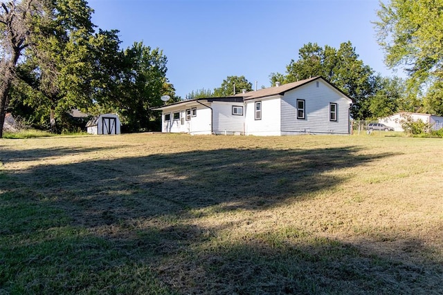 exterior space with a yard and a storage shed