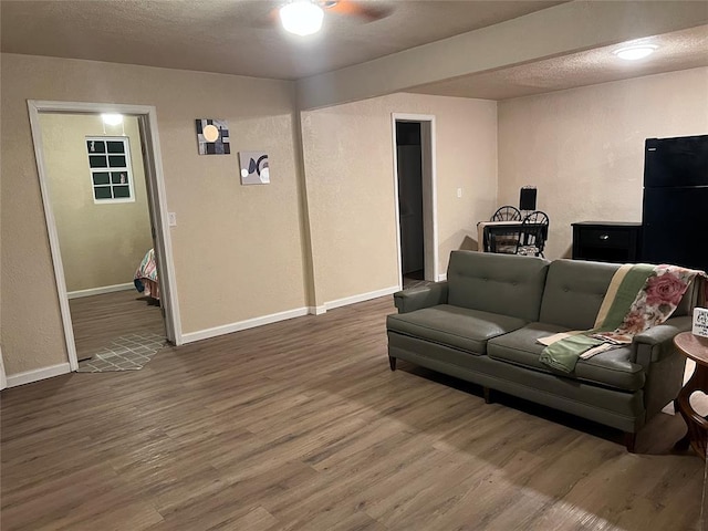 living room with hardwood / wood-style floors and a textured ceiling