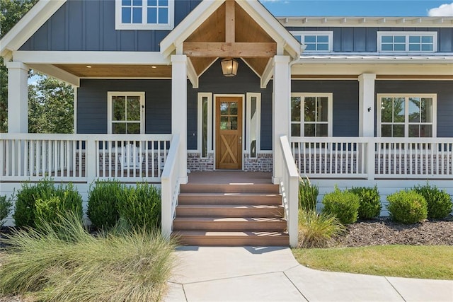 view of exterior entry with a porch