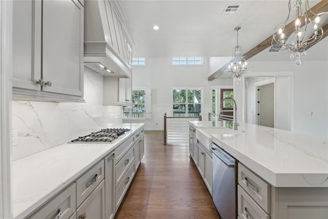 kitchen with pendant lighting, a spacious island, sink, dark hardwood / wood-style floors, and stainless steel appliances