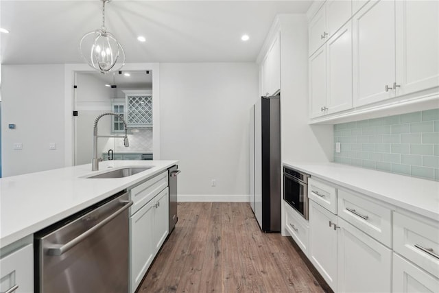 kitchen with sink, dark hardwood / wood-style flooring, white cabinets, and appliances with stainless steel finishes