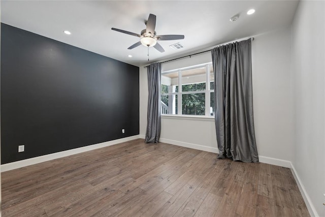 empty room with ceiling fan and hardwood / wood-style floors