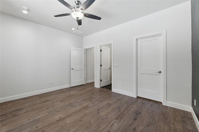 unfurnished bedroom with ceiling fan and dark hardwood / wood-style floors