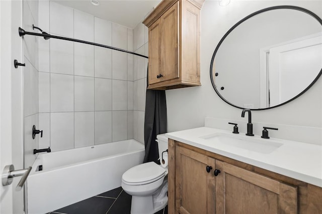 full bathroom featuring tile patterned flooring, tiled shower / bath combo, toilet, and vanity