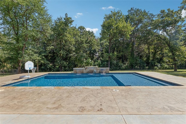 view of swimming pool with pool water feature