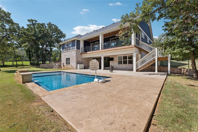 exterior space featuring a yard, pool water feature, and a patio area