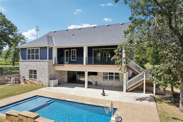 rear view of house with a balcony and a patio