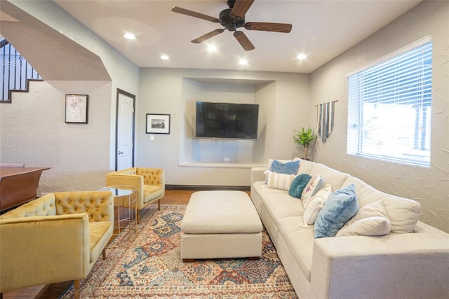 living room featuring ceiling fan and hardwood / wood-style flooring