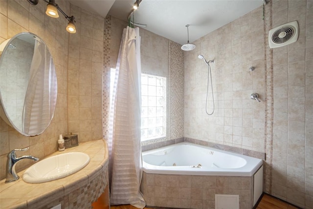 bathroom with tile walls, sink, and hardwood / wood-style floors