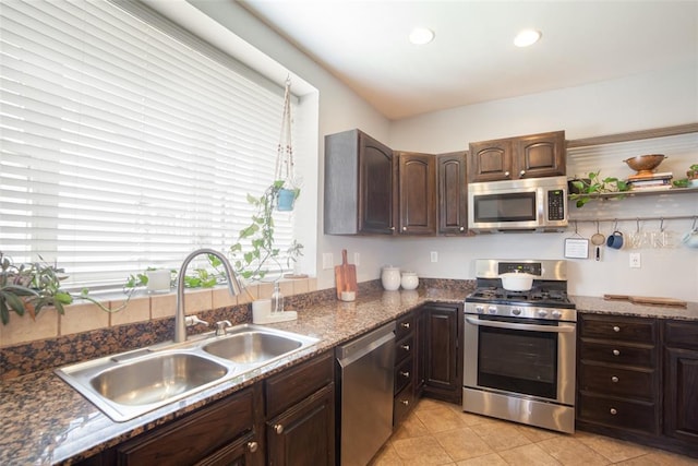 kitchen with light tile patterned floors, sink, stainless steel appliances, and dark brown cabinetry