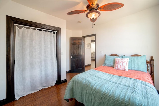 bedroom featuring dark wood-type flooring and ceiling fan