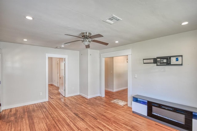 empty room featuring ceiling fan and light wood-type flooring