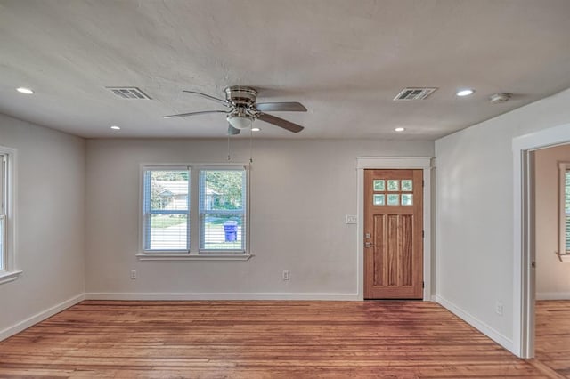 foyer entrance with ceiling fan and light hardwood / wood-style flooring