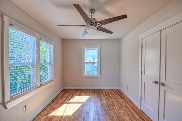 unfurnished room with light hardwood / wood-style floors, plenty of natural light, and ceiling fan