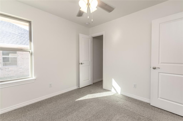 unfurnished bedroom featuring ceiling fan and light carpet