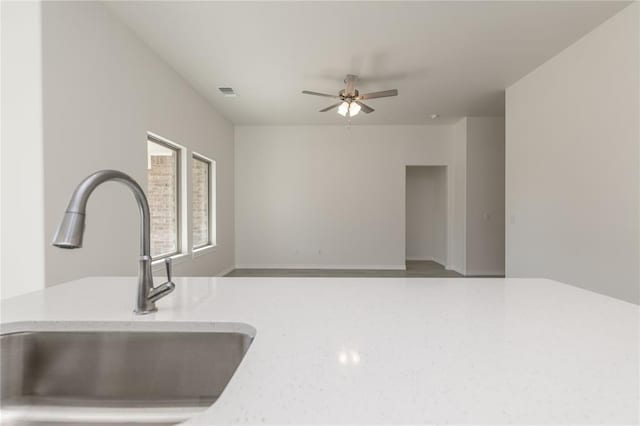 kitchen with ceiling fan and sink