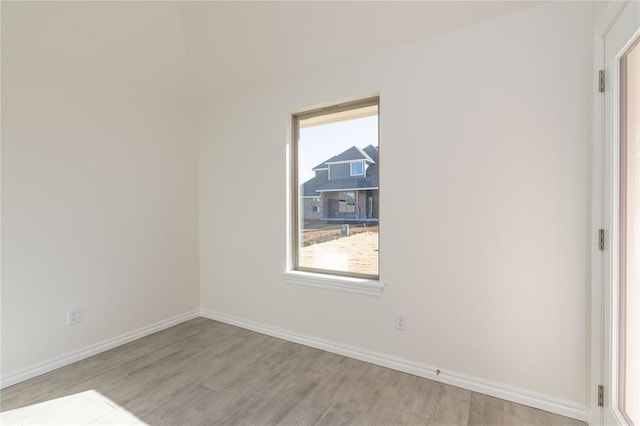 spare room with light hardwood / wood-style floors