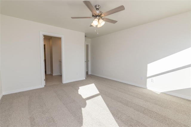 unfurnished bedroom featuring ceiling fan, light colored carpet, and a walk in closet