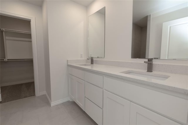 bathroom featuring tile patterned flooring and vanity