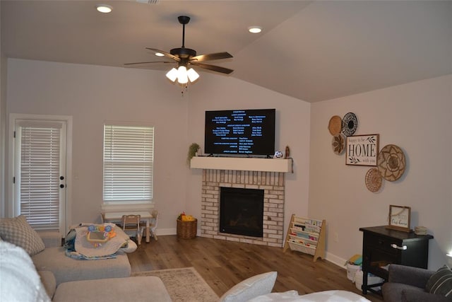 living room with a fireplace, wood-type flooring, ceiling fan, and lofted ceiling