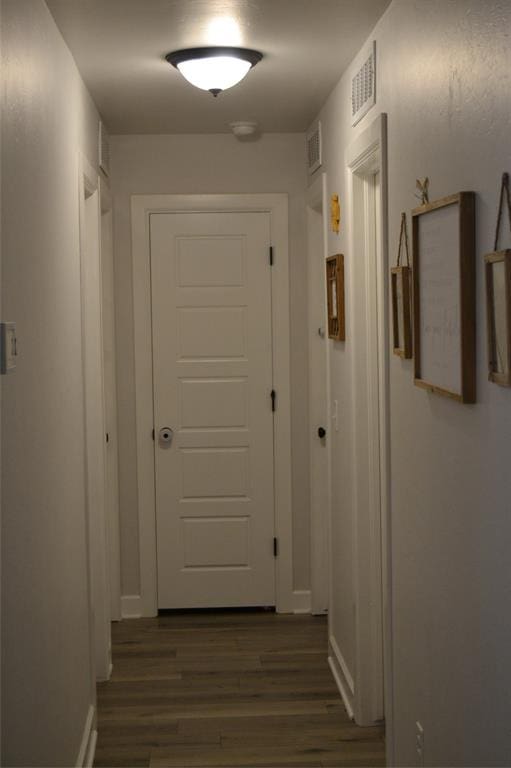 corridor with dark wood-type flooring