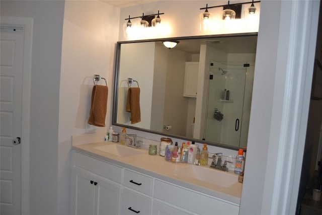 bathroom with vanity and a shower with shower door