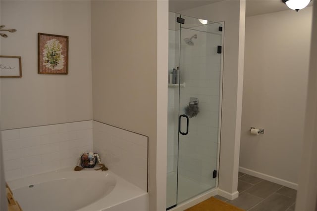 bathroom featuring tile patterned floors and shower with separate bathtub