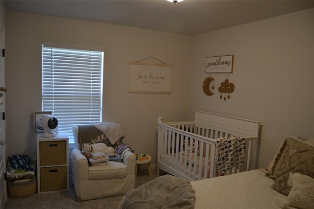 bedroom with carpet flooring and a nursery area