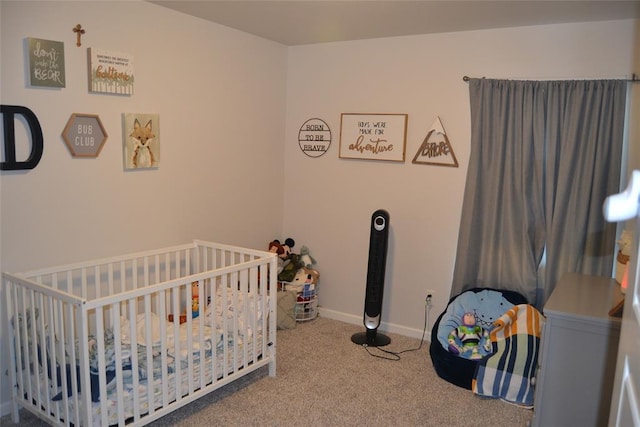 bedroom featuring carpet and a nursery area