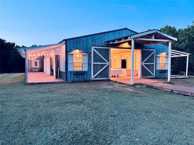 exterior space featuring a front lawn and an outdoor structure