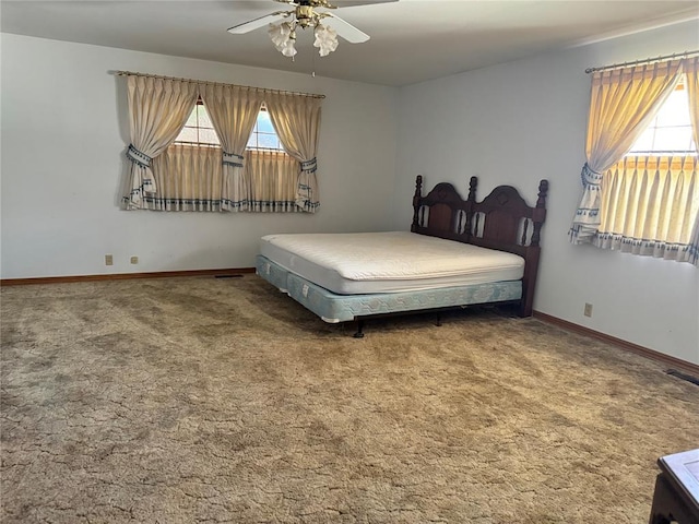 bedroom with carpet, ceiling fan, and multiple windows