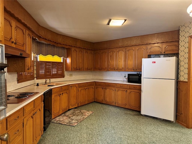 kitchen featuring black appliances, sink, and light carpet