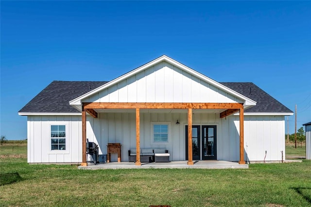 rear view of house with an outdoor living space, a yard, and a patio