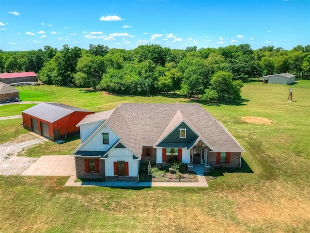 view of front of home with a garage, an outbuilding, and a front lawn