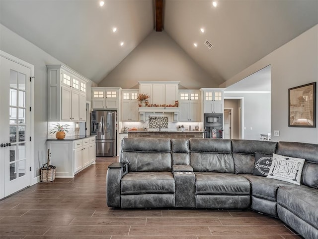 living room featuring beamed ceiling, dark wood-type flooring, and high vaulted ceiling