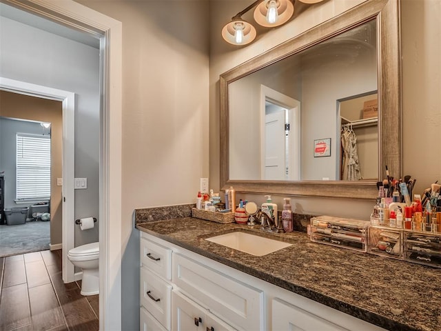 bathroom featuring vanity, a shower with shower curtain, and toilet