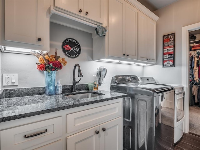 laundry room with separate washer and dryer, sink, cabinets, and dark hardwood / wood-style floors