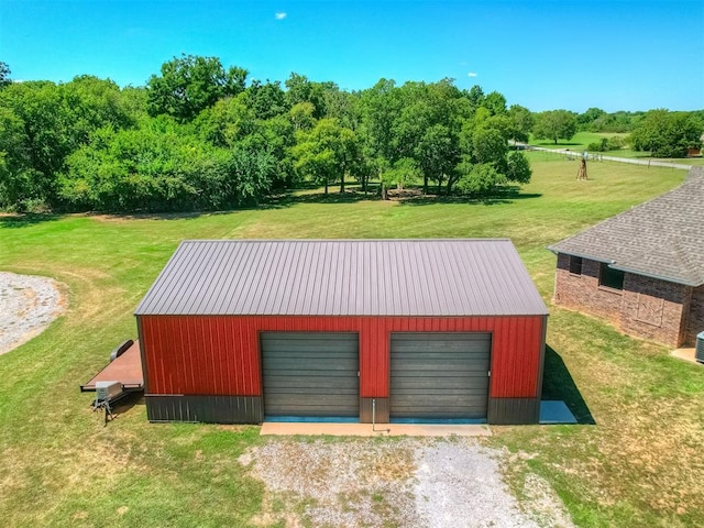 exterior space featuring a garage and a lawn