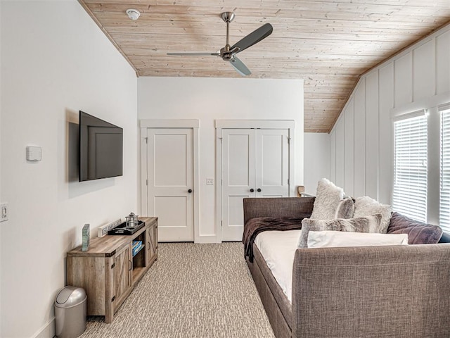 carpeted bedroom featuring ceiling fan, wood ceiling, and vaulted ceiling