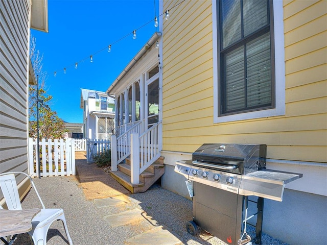 view of patio / terrace with a grill and a sunroom