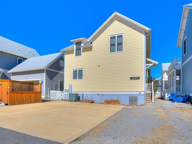 back of house with central AC unit